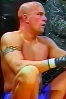 Tracy Hess seated in the cage corner during a fight